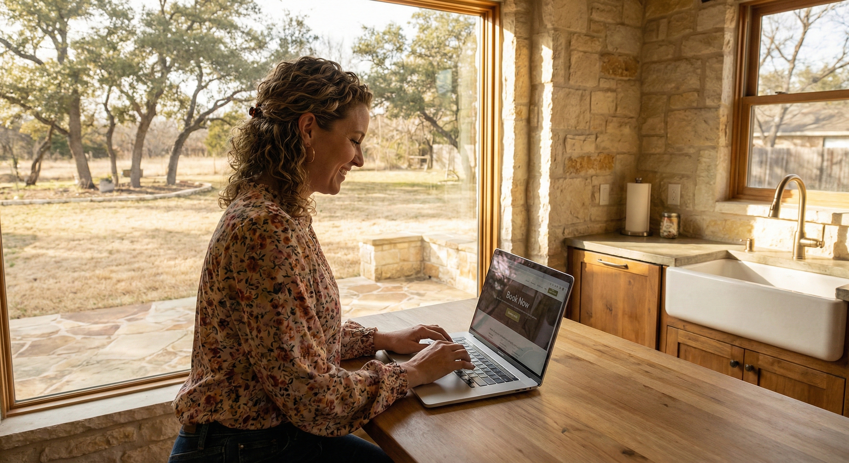 Woman booking cleaning service on laptop in sunny kitchen
